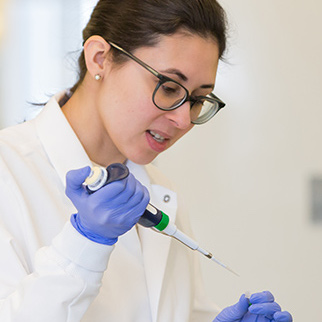 A researcher uses a syringe to conduct an experiment