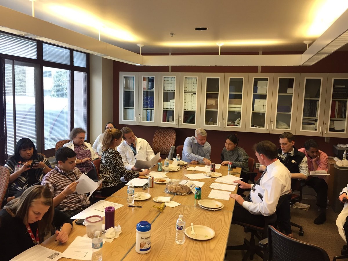 People talking and reading around table